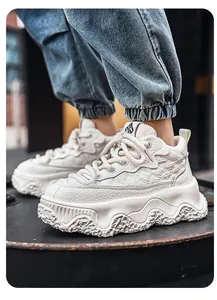 Side view detail of white chunky bread sneakers with embossed texture on industrial background