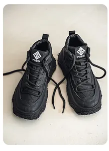 A detailed top view of stylish black high-top outdoor casual leather bread boots