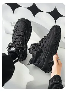 Detail of black warm leather chunky sneakers featuring thick wavy rubber soles for winter