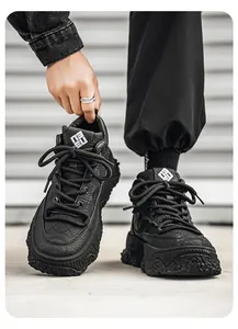 Macro view of chunky black high-top sneakers with thick textured soles and leather upper
