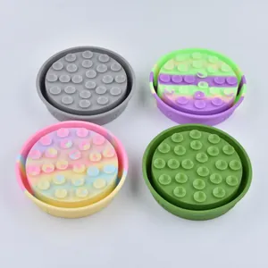 Set of four silicone slow feeder pet bowls with suction cups in assorted vibrant colors