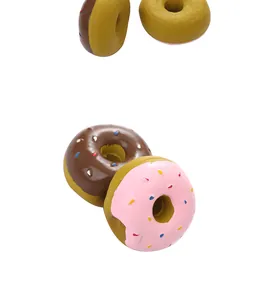 Close-up detail of colorful pink and chocolate latex squeaky donut chew toys for pet dogs