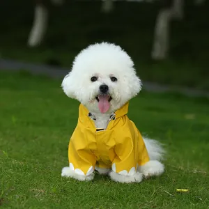 Adorable yellow waterproof dog raincoat featured on a white Bichon Frise puppy outdoors
