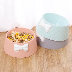 Macaron colored pet bowls with white bowknot decorations and diamond texture pattern detail