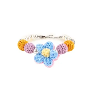 Detailed view of handmade crochet flower pet collar with white pearls and metal clasp