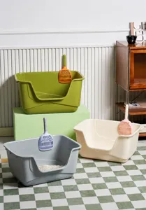 Three large semi-enclosed cat litter boxes in olive green, gray and cream with scoops