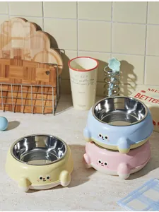 Three colorful stainless steel pet bowls for cats and dogs in a cozy kitchen setting.