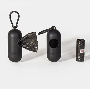 Close-up of black pill-shaped dog poop bag dispensers and a roll of waste bags.