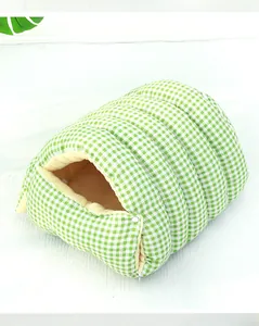 Detailed view of the soft plush lining and green checkered pattern of the pet nest.