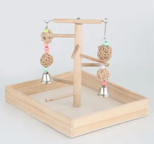 Natural wooden parrot stand featuring multiple perches and colorful hanging bell toys