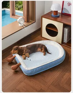 Brown dachshund relaxing on a light blue cooling pet bed in a sunny indoor setting.