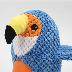 Parrot plush dog toy with squeaker and durable textured fabric for interactive chewing.