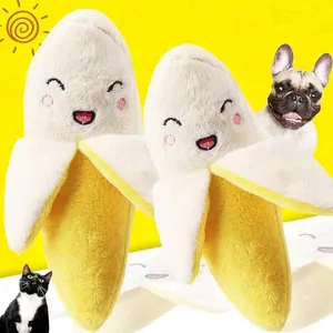 Detail view of cute banana plush dog toy with embroidered smiley faces