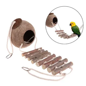 Detail view of natural coconut shell bird nest with wooden climbing ladder for parrots.