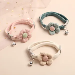 Detailed close-up of cute adjustable pet collars with knitted flowers and bells in three colors