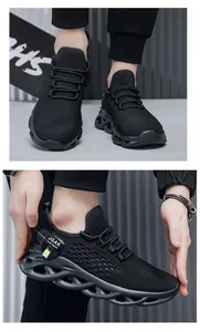 Close-up of black breathable flyknit sneakers with hollowed-out braid sole