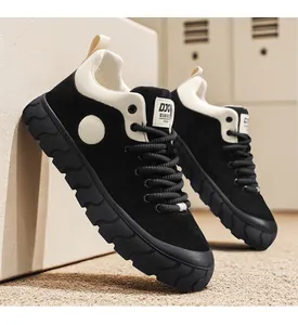 Detailed side view of black and beige chunky retro sneakers with thick rope laces