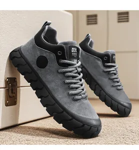 Close-up of stylish grey suede platform sneakers with unique textured soles in studio