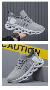 Detail of grey breathable flyknit running shoes featuring a unique white wave twist sole.