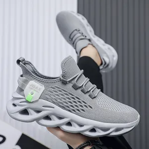 Lightweight grey mesh running shoes for men with unique hollowed-out twist sole design.