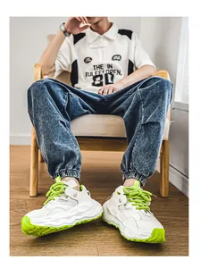 Fashionable white and neon green men's chunky mesh sneakers shown in a lifestyle setting