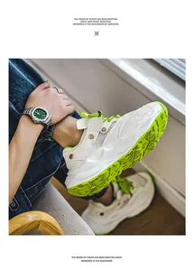 Detailed view of white and neon green men's chunky sneakers with breathable mesh.