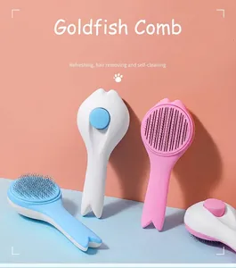 Detail showing self-cleaning pet brush in cute goldfish design with one-click hair removal