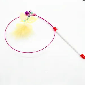 Detailed close-up of cat teaser wand with pink steel wire, yellow feathers, and bell
