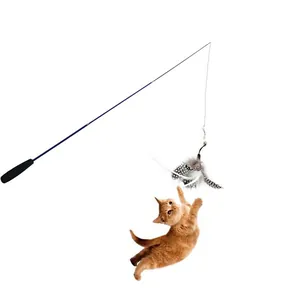 Detail view of a retractable cat wand with feather being caught by a jumping kitten