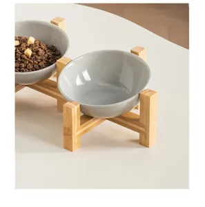 Detailed view of the slanted grey ceramic pet bowl on a natural bamboo stand structure