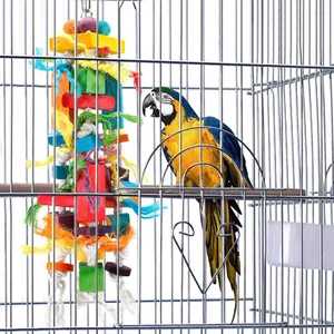 Large colorful wooden parrot chew toy hanging in a metal cage with a macaw parrot