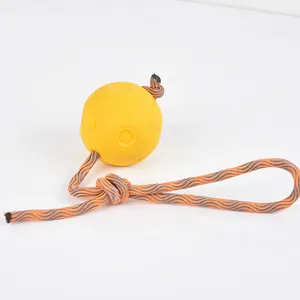 Durable yellow TPR dog toy ball with orange braided tug-of-war rope for heavy chewers