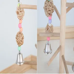 Detail view of parrot toy accessory featuring rattan balls, colorful beads, and a metal bell