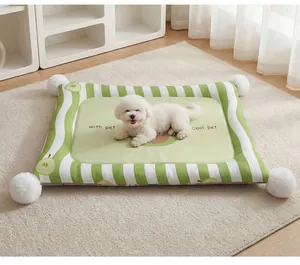 Close-up of green striped pet cooling mat with soft white pom-poms and cute dog