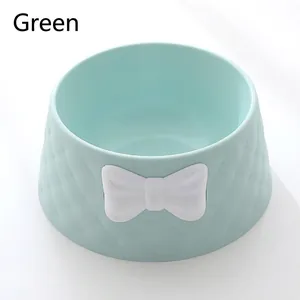 Close-up of green pet bowl featuring diamond texture and white bowknot