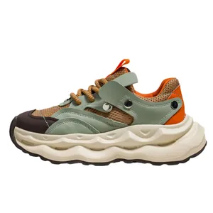 Men's breathable mesh chunky sneaker with thick cream sole and green overlays.