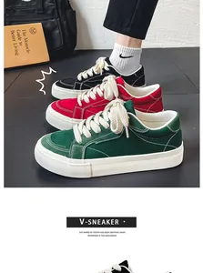 Detail van drie paar retro canvas sneakers in de kleuren groen, rood en zwart