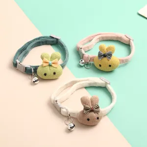 Detailed view of soft fabric pet collars with knitted rabbit charms and silver bells.