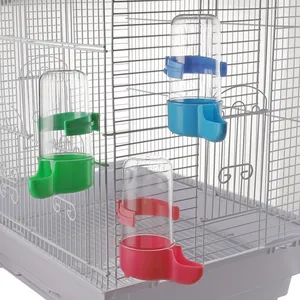 Automatic bird waterers in multiple colors installed on a white wire bird cage