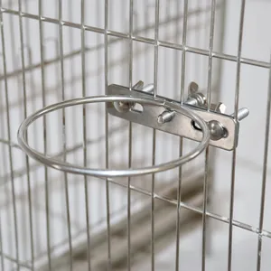 Detail view of stainless steel ring bracket for bird feeder mounted on wire cage.