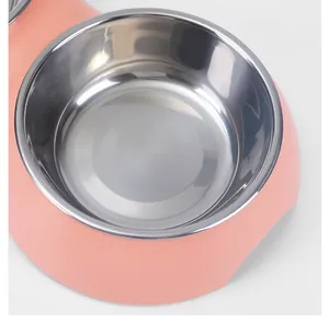 Close-up detail of a removable stainless steel inner bowl in a pink pet feeder.