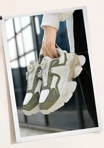 Macro view of men's breathable mesh athletic shoes featuring a unique rotary buckle