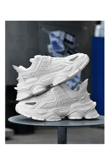Close-up of white breathable mesh sneakers with chunky soles stacked on a stand