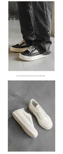 Vue détaillée des baskets en cuir pour hommes de style high-street en blanc et noir.