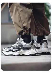 Close-up view of retro silver and white chunky dad sneakers with breathable mesh panels