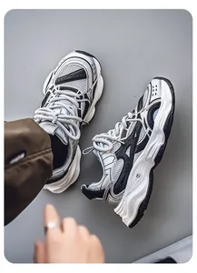 Close-up detail of retro chunky running sneakers in silver and black mesh synthetic design