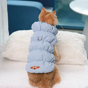 Warm light blue puffer vest for cats and small dogs featuring harness D-ring design