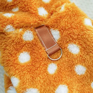 Close-up of the metal D-ring and polka dot plush fabric on the pet Christmas outfit