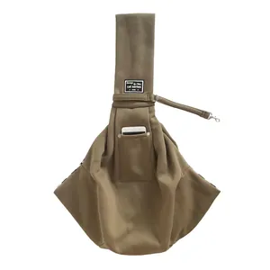 Detail view of a brown pet sling carrier bag with a convenient front phone pocket.