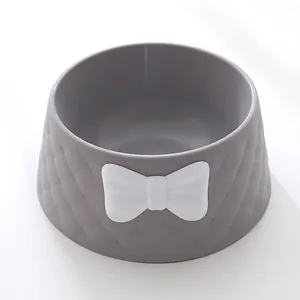 Close-up of a grey pet bowl featuring a diamond texture and decorative white bow